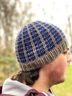 a close up of a person wearing a knitted hat and looking off into the distance