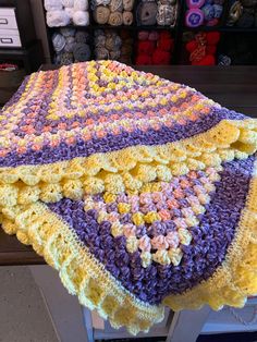 a crocheted blanket sitting on top of a table