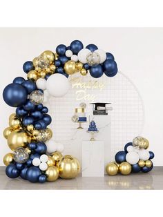 a blue and gold balloon arch with balloons