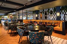 an empty restaurant with colorful chairs and tables