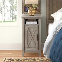 a bedroom with a bed, nightstand and mirror on the side table in front of it