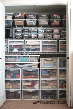 an organized closet with clear drawers and plastic bins