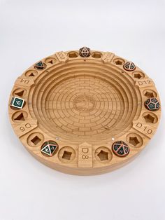 a wooden plate with several different shapes and numbers on it's side, sitting on a white surface