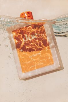 an orange dice floating on top of water