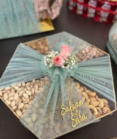 there is a card with some flowers on it and nuts in front of the card