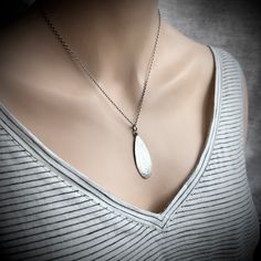 This teardrop pendant necklace is handmade from solid sterling silver. I have cut a teardrop from a sheet of silver using my jeweler's saw. I then used a variety of vintage hammers to create its unique texture. I have attached the bail with a wire-wrapped loop and suspended the pendant along a sterling silver chain. The chain features a 3-inch extender which allows it to be slightly adjustable. The silver has been oxidized and polished to create an antique patina finish.Be sure to see all photos and video for size and color reference.Teardrop Size: About 15x40mmSelect your necklace length when ordering. Total necklace length is measured from end to end and includes all parts of chain and clasp.The necklace photographed is shown at an 18-inch length modeled on a women's size S/M mannequin w Cheap Metal Teardrop Pendant Jewelry, Cheap Teardrop Pendant Jewelry With Adjustable Chain, Handmade Sterling Silver Drop Necklace With Teardrop Pendant, Handmade Sterling Silver Drop Necklace, Silver Diamond Teardrop Pendant Necklace, Everyday Silver Teardrop Drop Necklace, Handmade Sterling Silver Teardrop Drop Necklace, Nickel Free Silver Teardrop Drop Necklace, Sterling Silver Oxidized Teardrop Pendant Necklace