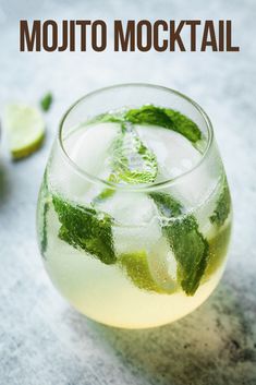 the mojito cocktail is garnished with mint and lime