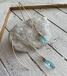 Perfect for summer, our Aqua Drop Earrings are lite weight and just the right amount of fun to easily go from day to night. Earrings measured approximately 2.25” from top to bottom Material is 14k gold filled ear wire and aqua colored glass As with all jewelry, keep dry and clean with cloth provided. 14k Gold Filled Teardrop Linear Earrings, 14k Gold Filled Teardrop Threader Earrings, Turquoise 14k Gold-filled Earrings With Ear Wire, Turquoise 14k Gold Filled Earrings For Everyday, 14k Gold-filled Turquoise Jewelry With Ear Wire, Everyday Turquoise 14k Gold Filled Earrings, Turquoise 14k Gold Filled Earrings, Day To Night, Aqua Color