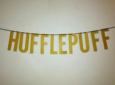 a bunting banner with the word hufflepuff hanging from it's side