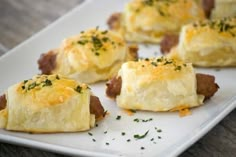 small pastries with meat and cheese on a white plate