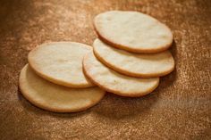 four crackers sitting on top of a wooden table