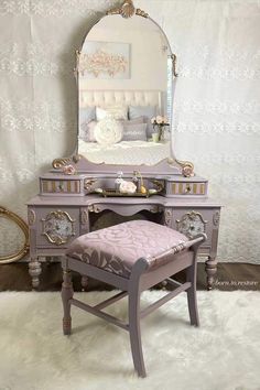 an antique vanity with a stool and mirror