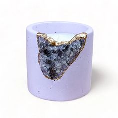 a candle that has some kind of animal on it's face in front of a white background