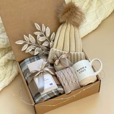 a gift box containing coffee, socks and a knitted hat