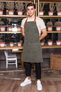 "Apron: 132BBF - Baxter Green * Chic and durable green denim apron, with neck strap, pockets and special tool or towel holder. Stylish, modern and comfortable all-day wear. * Available sizes: S/M: 70 x 55 cm (27.5\" x 21.5\") L/XL: 85 x 65 cm (33.5\" x 25.5\") * Pocket: Two pockets, center one at chest area and a larger one at left side of waist area. Both of them are perfect for your notebooks, PDAs, pens and bartending or other small tools. * Straps: Strong adjustable genuine Italian cow leather neck strap in light brown color, featuring metal bronze details for customizing the fit and buttons on both ends, for easy removal before washing. Straps on each side of the apron that can be tied around the waist. * Usage: Exclusively and thoughtfully designed for professionals such as baristas, Custom Apron, Denim Apron, Apron Kitchen, Custom Aprons, Kitchen Apron, Pastry Chef, Kitchen Aprons, Linen Apron, Neck Strap