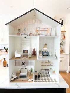 a doll house is shown with all the furniture in it's white and black color scheme