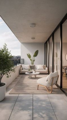 an outdoor living area with white furniture and potted plants on the balcony overlooking the city