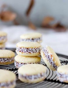 some cookies are on a cooling rack and have powdered sugar on them as well