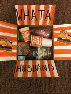 an orange and white striped bag with some food in it that says whata husband