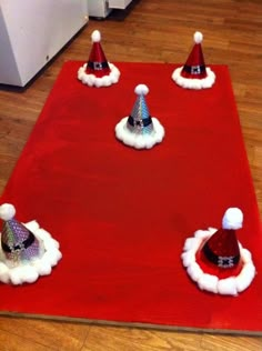 a red carpet with santa hats on top of it and other decorations around the area