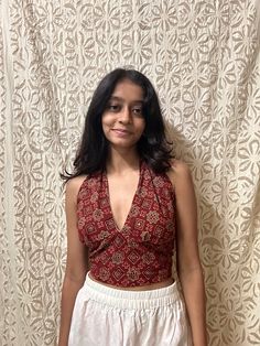 this beautiful maroon halter neck top is from a small business on instagram, They have beautiful tops with a touch of indian prints! Comment to get the name of this store #halternecktop #aesthetictops #traditionaltops #halterneck #outfits #fashion #ootd Halter Neck Tops Outfit, Cotton Halter Top, Halterneck Saree Blouse, Halter Neck Top And Skirt, Tops From Saree, Halter Neck Short Kurti, Halter Neck Top Outfit Casual, Halter Neck Top Pattern Sewing, Indian Print Tops