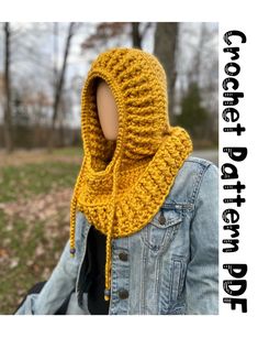 a woman wearing a yellow crocheted cowl scarf in front of a park