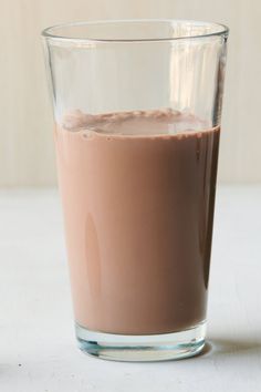 a glass filled with chocolate sitting on top of a table