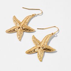 Give yourself instant island vibes with these drop earrings. These stylish gold-tone earrings have texturized starfish charms that are perfect for warm-weather fun. Finish: Gold-tone Drop: 1" Closure: Fish hook Material: Metal - Claire's Gold Starfish 1" Drop Earrings Gold Dangle Earrings For Beach Season, Summer Gold Jewelry With Star Charm, Gold Drop Earrings For Vacation, Gold Earrings For Beach Season, Gold Star Earrings For Summer, Gold Starfish Jewelry For Vacation, Star Charm Drop Earrings For Beach, Nickel-free Gold Earrings For Vacation, Summer Beach Earrings With Starfish Charm