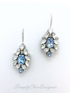 Elegant Vintage style Bridal Earrings. Made with high-quality Swarovski rhinestones in light blue and clear crystals, finished with elegant crystallized french hooks. Designed and created in SimplyChic studio Matching necklace available at this link: https://www.etsy.com/listing/782914818/sapphire-light-blue-statement?ref=shop_home_active_2&frs=1 Matching bracelet: https://www.etsy.com/listing/786999339/sapphire-light-blue-statement?ref=shop_home_active_43&pro=1&frs=1 Matching hair a Elegant Blue Crystal Chandelier Earrings, Blue Cubic Zirconia Chandelier Earrings For Party, Elegant Blue Rhinestone Earrings, Blue Cubic Zirconia Dangle Chandelier Earrings, Elegant Jeweled Blue Crystal Earrings, Blue Jeweled Earrings For Wedding, Elegant Blue Jeweled Crystal Earrings, Blue Crystal Dangle Bridal Earrings, Blue Crystal Earrings For Wedding