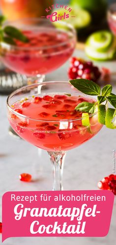 two glasses filled with pink liquid and garnished with green leaves