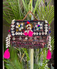 About bag  Indo-gypsy fusion, everyday use hand bag made from Banjara fabrics sourced from Vintage tribal costumes of regions of Rajastan and Gujarat. These are embellished with light catching coins, and intricate bead work tassels. Size - length 15 inches/ width 21 inches Company details:  Company name: Houseoftextile  Contact number: +919784447473  Email id: houseoftextile77@gmail.com  Shipping & custom : Delivery through one of the finest service providers : Skyway, Fedex, UPS  And DHL. Any l Festival Shoulder Bag With Multicolor Embroidery And Handwork, Multicolor Embroidered Handwork Shoulder Bag For Festivals, Festival Bag With Mirror Work, Rectangular Shape, Festival Rectangular Bag With Mirror Work, Handmade Pouch Bag For Navratri, Rectangular Bags With Multicolor Embroidery And Tassels, Multicolor Embroidered Festival Bag, Festival Rectangular Bags With Multicolor Embroidery, Multicolor Handwork Pouch Shoulder Bag