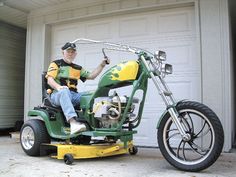 a man riding on the back of a green motorcycle next to a white garage door