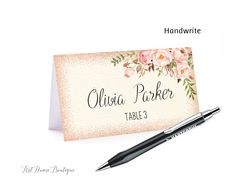 a place card with a pen on top of it next to a note that says, julia parker table 3