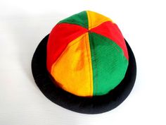 This Rasta Jamaican Bucket hat is perfect for Summer Reggae Festivals. This solid Bucket hat features a Jamaican Rasta Inspired Striped Band atop a solid , Red green yellow Rasta color bucket hat. Rock this hat as you dance the night away at your next outdoor concert or event. Fashionable and a must-have . This Hat is unisex that looks great on both men and women . This Hat is very durable and can be used as a special gift . -Solid Unisex Jamaican Adult Sun Hat -Rasta Reggae Inspired Striped Ban Adjustable Multicolor Wide Brim Cloche Hat, Adjustable Brimmed Cloche Hat For Festival, Adjustable Multicolor Costume Cap, Retro Adjustable Costume Hat, Adjustable Multicolor Brimmed Costume Hats And Headpieces, Retro Multicolor Sun Hat With Short Brim, Adjustable Multicolor Costume Hat, Retro Multicolor Short Brim Hat, Multicolor Short Brim Mini Hat