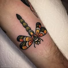 a close up of a person's arm with a tattoo on it and a red circle in the middle