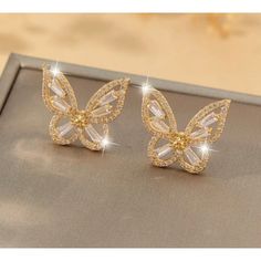 These Exquisite Gold Butterfly Stud Earrings Are Adorned With Sparkling Rhinestones, Offering A Sophisticated Touch To Any Outfit. Perfect For Special Events And As A Thoughtful Gift. Gold-Plated Metal Crystal Rhinestone Inlay Butterfly Shape Sparkling Finish Stud Closure Lightweight Design 0.748 In X 0.669 In Gold Crystal Earrings With Rhinestones Gift, Gold Crystal Earrings With Rhinestones, Gold Butterfly Earrings For Party, Elegant Butterfly Earrings With Diamond Accents, Butterfly Shaped Earrings With Diamond Accents, Gold Butterfly-shaped Crystal Jewelry, Gold Crystal Butterfly Jewelry, Butterfly Cubic Zirconia Wedding Earrings, Wedding Butterfly Cubic Zirconia Earrings