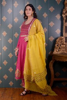 Magenta anarkali with floral foil print and lace trim on the neckline and sleeve hems. Comes with straight pants and mustard yellow chanderi dupatta.
Component: 3
Pattern: Print and Embroidery
Type Of Work: Foil Print, Sequin and Thread
Neckline: Round
Sleeve Type: Full
Fabric: Anarkali: Banarasi Chanderi, Pant: Cotton Satin and Dupatta: Chanderi
Color: Magenta
Other Details: 
Floral print dupatta with scalloped border
Lace trim on the neckline, bodice and sleeve hem
Occasion: Puja - Aza Fashion Magenta Anarkali, Chanderi Dupatta, Border Lace, Scalloped Border, Color Magenta, Foil Print, Straight Pants, Set For Women, Anarkali