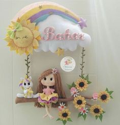 a doll is sitting on a swing with sunflowers and other toys in front of it