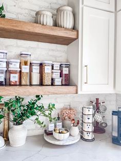 the kitchen counter is full of spices and herbs