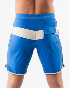 HIGHLIGHTS.. Unlined boardshort. 9” inseam Reflective branding at leg opening and back waistband Elastic waistband with adjustable self-tie drawcords Color-blocking panelling Water resistant fabric FIT SUGGESTION. This item runs true to Alphalete’s standard sizing.. Fit is based off of waist size in inches.. If you are between sizes, we recommend sizing up for a relaxed fit.. Eric is 6’2”/188cm, wearing a size 32. MATERIALS AND WASHING DIRECTIONS. 67% Nylon, 23% spandex. Due to the high saturati Blue Athletic Shorts With Built-in Shorts For Water Sports, Sporty White Shorts For Water Sports, Sporty Color Block Beach Shorts, Summer Workout Color Block Bottoms, Summer Color Block Workout Bottoms, Sporty Nylon Swim Trunks For Surfing, Sporty Blue Shorts With Drawstring, Sporty Swim Trunks With Pockets For Training, Fitted Swim Trunks With Pockets For Sports