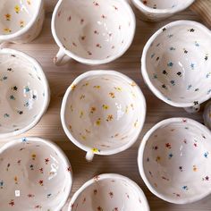 many white bowls with colorful stars on them