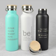 three stainless steel water bottles with wooden lid and carafe clip, one for drinking