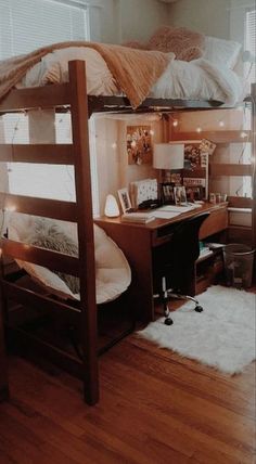 a bedroom with bunk beds and desk in it