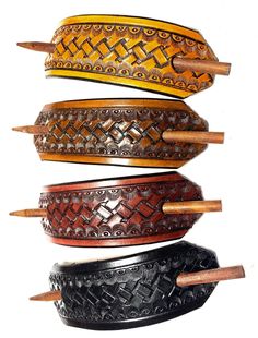 four different types of leather belts with wooden handles