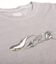 a grey t - shirt with the word wolf on it's chest and silver lettering