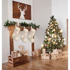 a christmas tree and presents in front of a fireplace