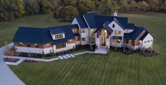 an aerial view of a large home in the evening