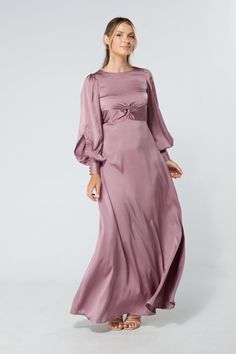 Description Composition Size This stylish lilac maxi dress with wide long sleeves is a refreshing new addition to the ladies' wardrobe. The soft and lavish crepe fabric is very light and smooth. The wide skirt flows gracefully from the waist down to elongate the legs. And the top fits perfectly on the shoulders and gives a flawless accentuated upper body.  Shape: Fitted and Maxi Sleeves: Floating Long Sleeves. Purple Button Closure with Big Cuffs Colour: Lilac Length: 60 inches or 152 cm (Our model is 172 cm and wearing a size S) Skirt Style: Flowy and Maxi Top Style: Knotted on front and button on back  Neckline: Closed neckline Pattern: Crepe  Zipper: Hidden Zipper Closes at The Side, Elasticated back Fabric: 95% Polyester, 3% Viscose, 2% Nylon. The fabric is very light and airy Occasion Lilac Maxi Dress, Crepe Maxi Dress, Wide Skirt, Maxi Tops, Dresses Xxl, 70 Dress, Style Expert, Crepe Fabric, Body Shape