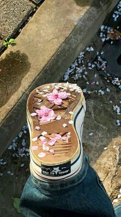 someone's shoes with pink flowers on them