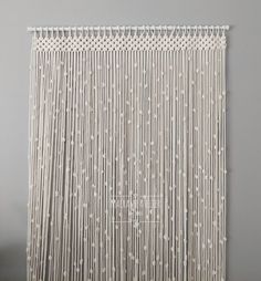 a white wall hanging on the side of a gray wall